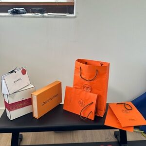 7 piece collection of authentic Chanel, Louis Vuitton and Hermés bags/boxes. BO.